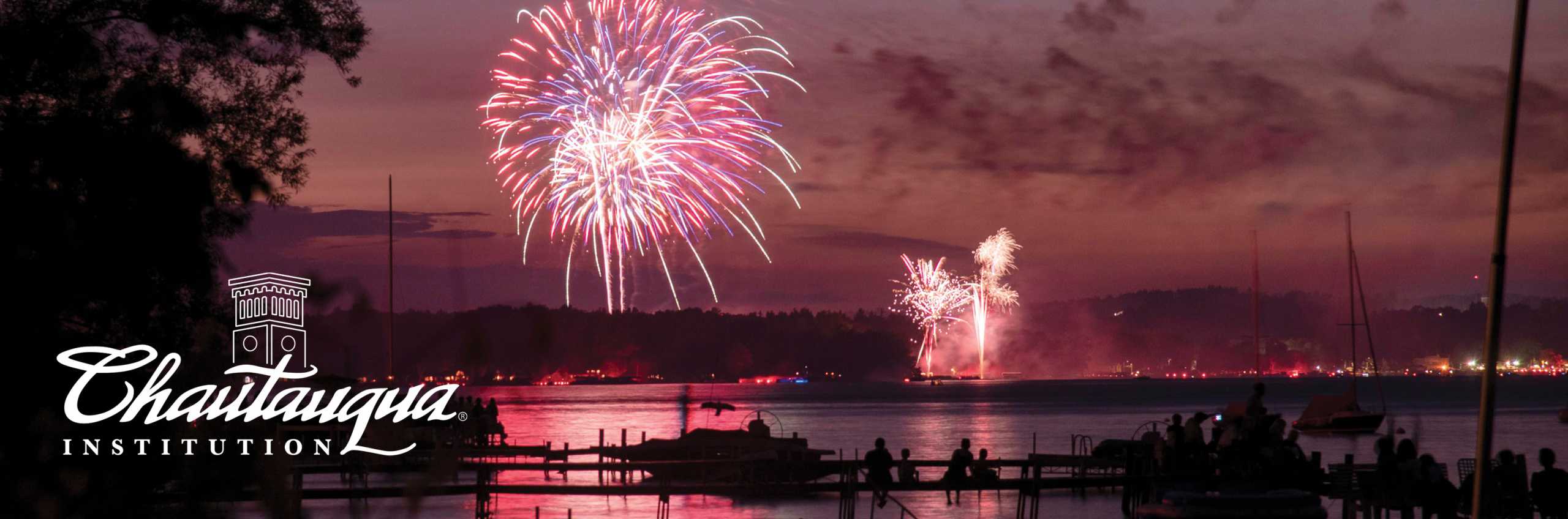 View of 4th of July fireworks down by the lake with Chautauqua Institution logo