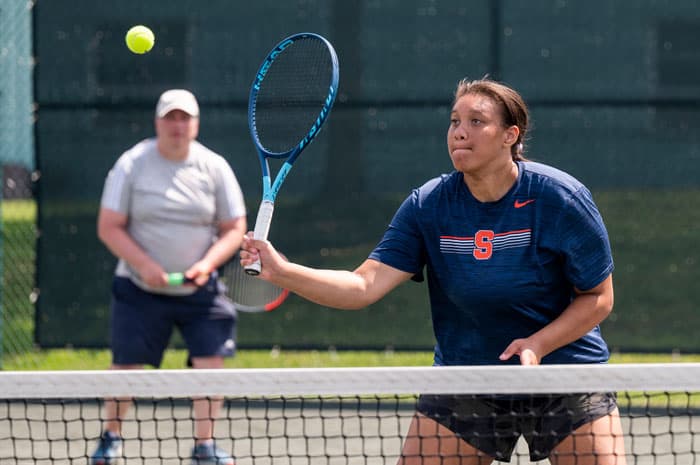 People in a tennis clinic