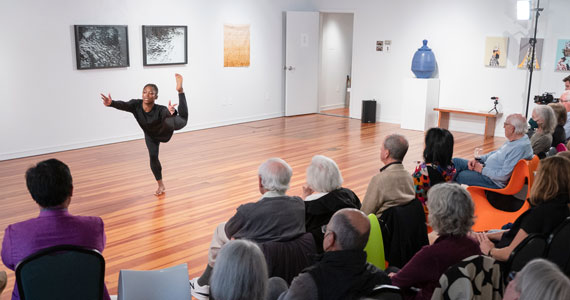 A dancer performing in an art gallery