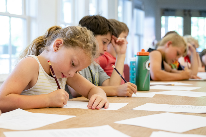 Children writing during a class