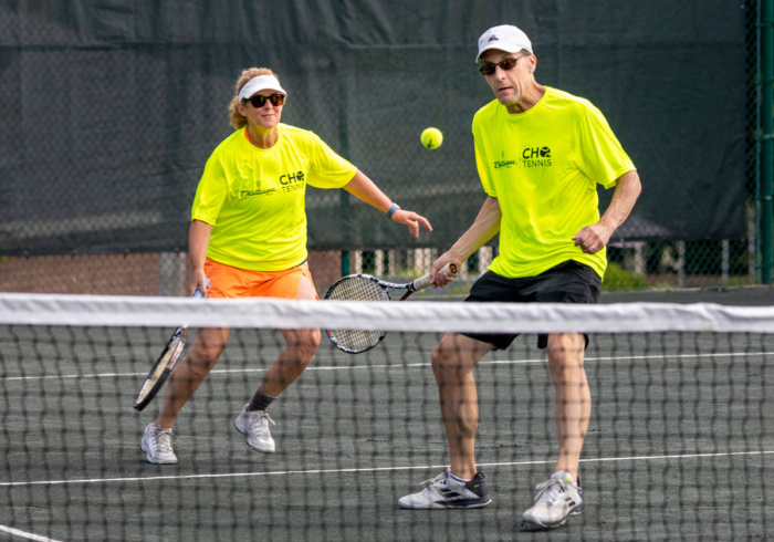 A man and woman playing tennis