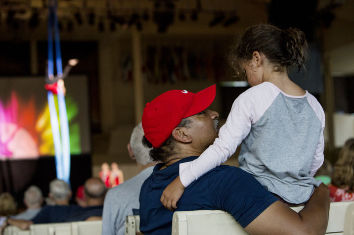 A family watching acrobats in the Amphitheater