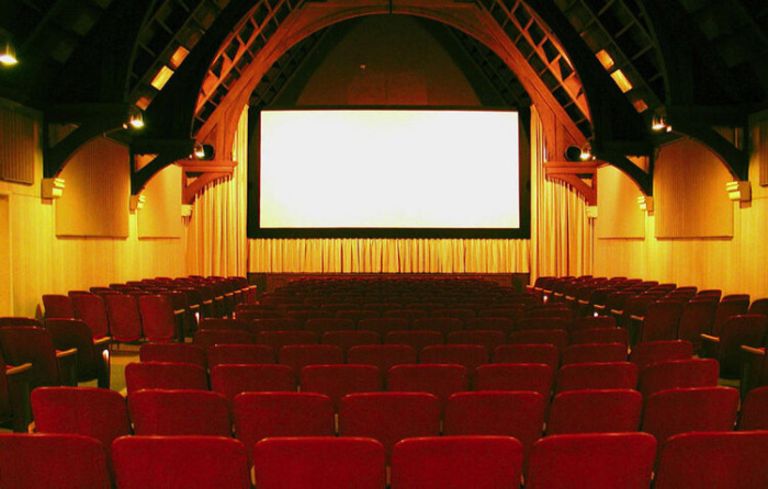 the rows of seats and screen in the cinema