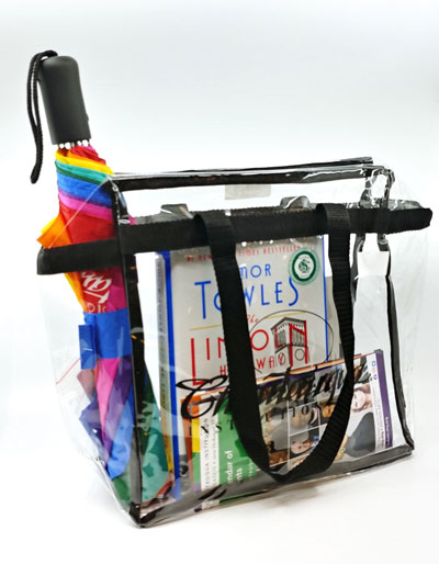 A clear stadium bag with books and an umbrella