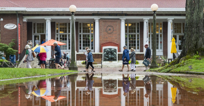 People walking through a rainy Bestor Plaza