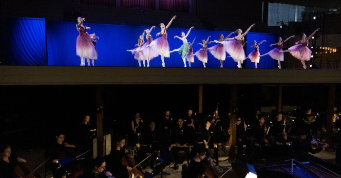 The School of Dance and Music School Festival Orchestra performing together in the Amphitheater
