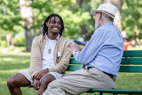 Two men talking on a bench