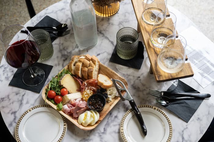 a table filled with wine and a charcuterie board