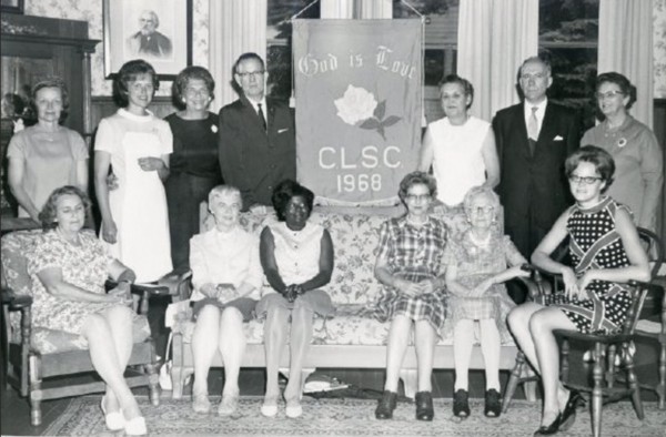 CLSC Class of 1968 gathered around their class flag