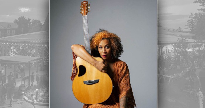 Rissi Palmer holding an acoustic guitar