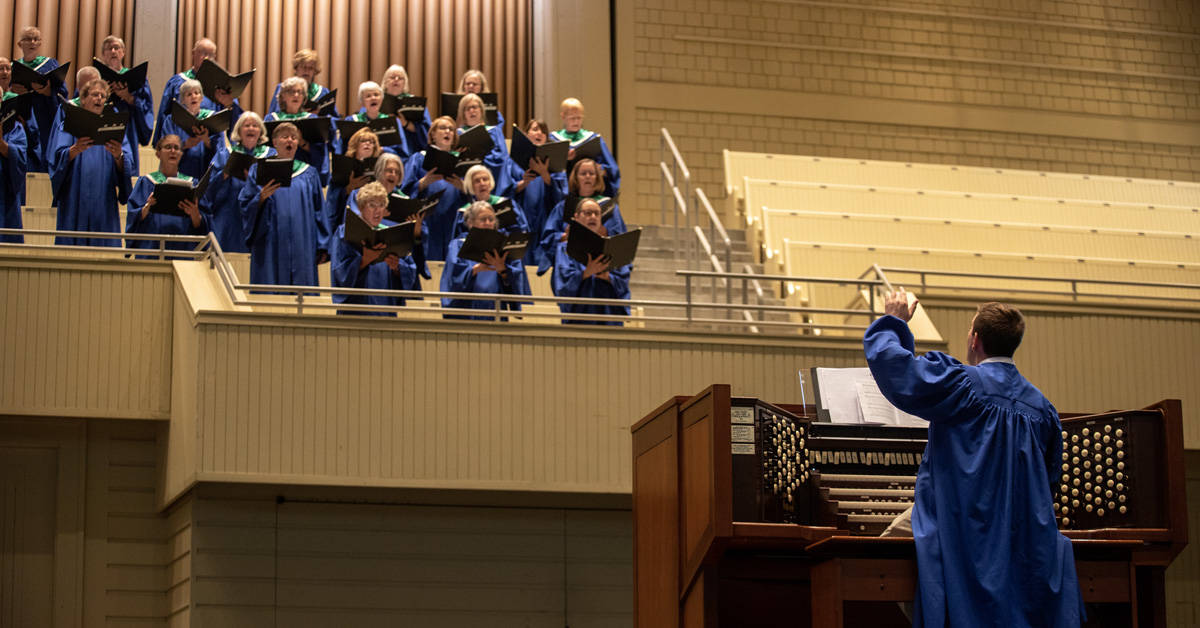 Josh Stafford leading the choir during a Sacred Song service