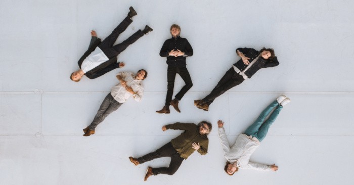 Wilco band members laying on the floor looking up at the camera