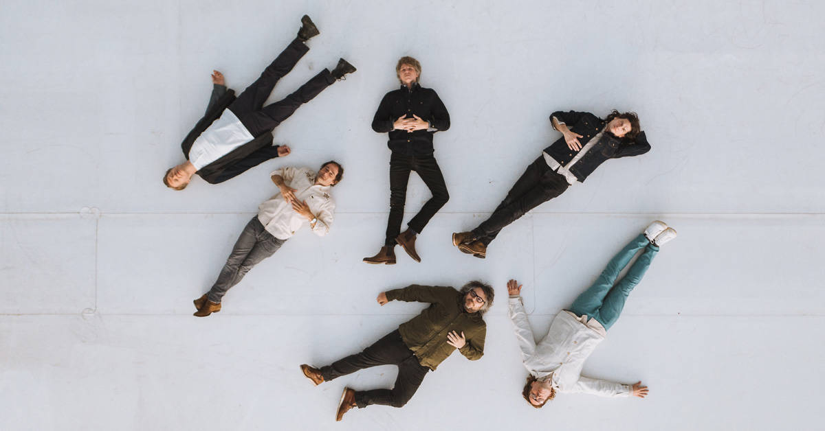 Wilco band members laying on the floor looking up at the camera