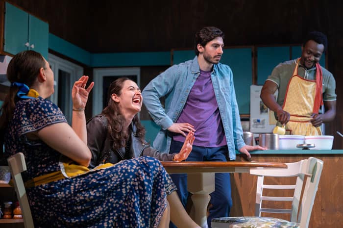 Actors laughing in a kitchen