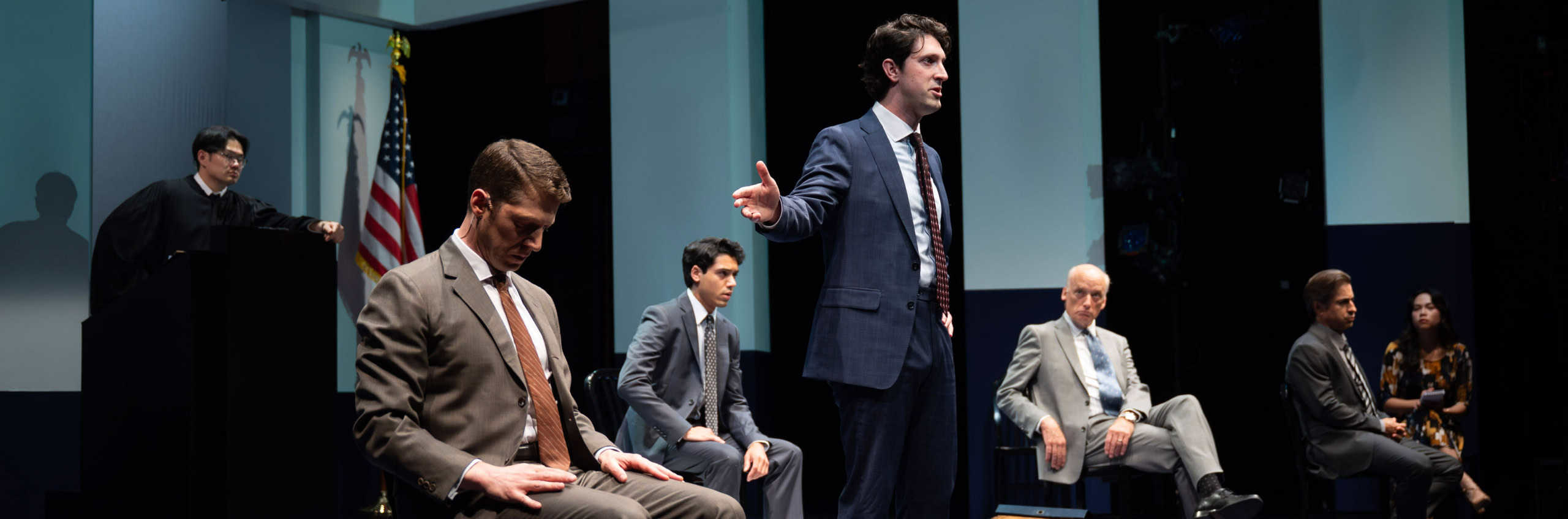 A scene of people in a court room from Execution of Justice