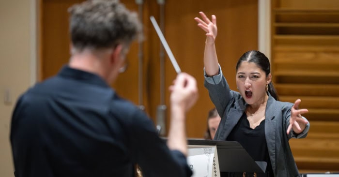 An opera singer and conductor during a performance