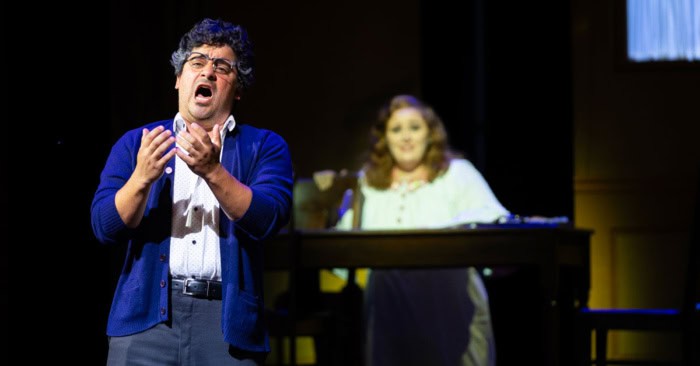 An opera singer in a blue sweater