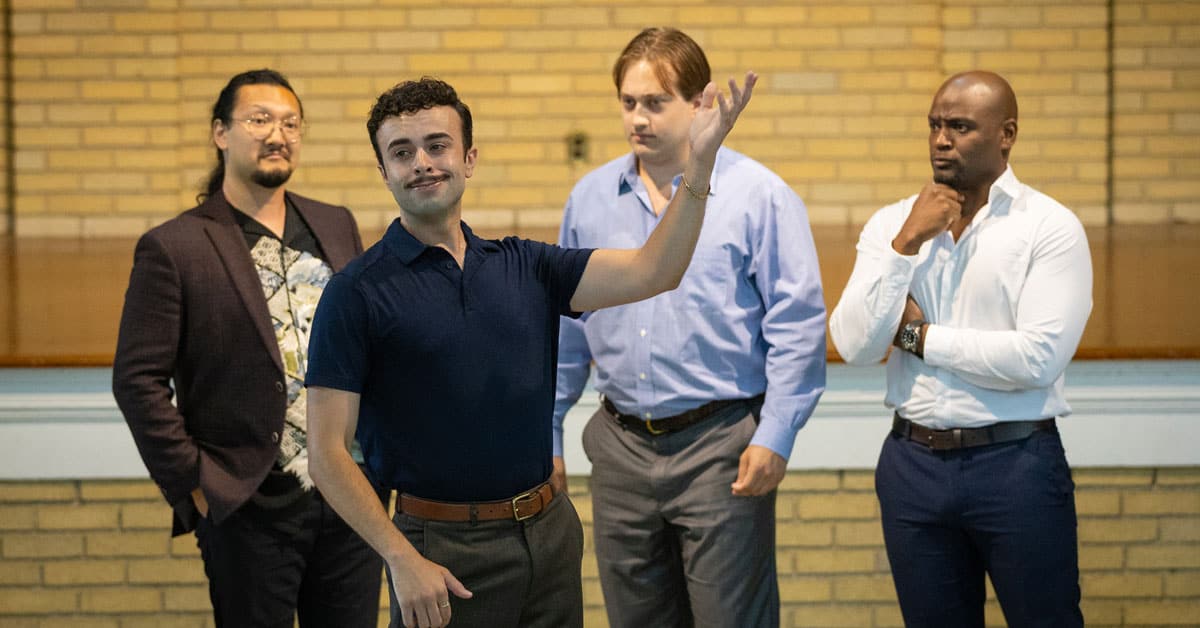 Four men standing in a group