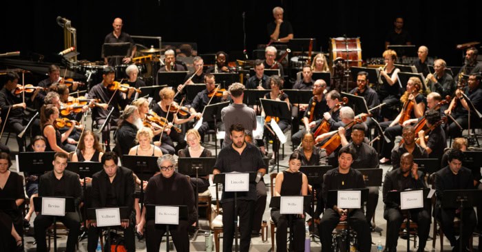 Opera singers and musicians on stage during a performance