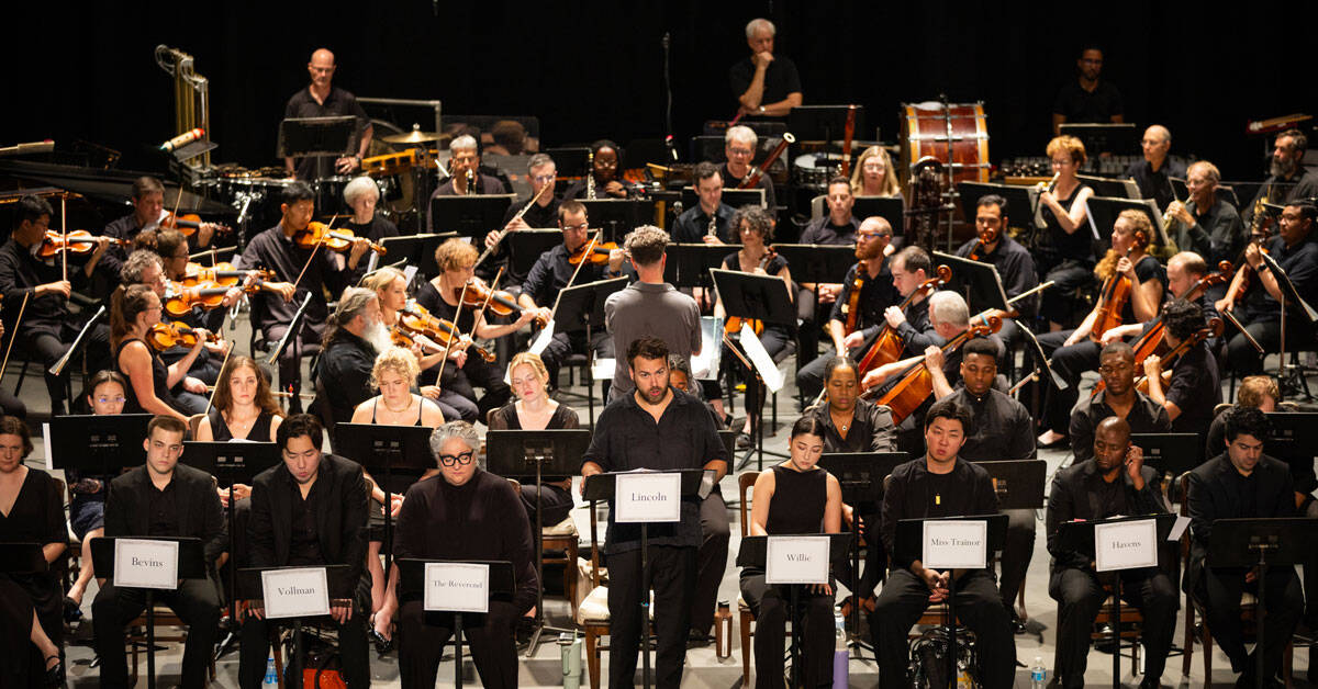 Opera singers and musicians on stage during a performance