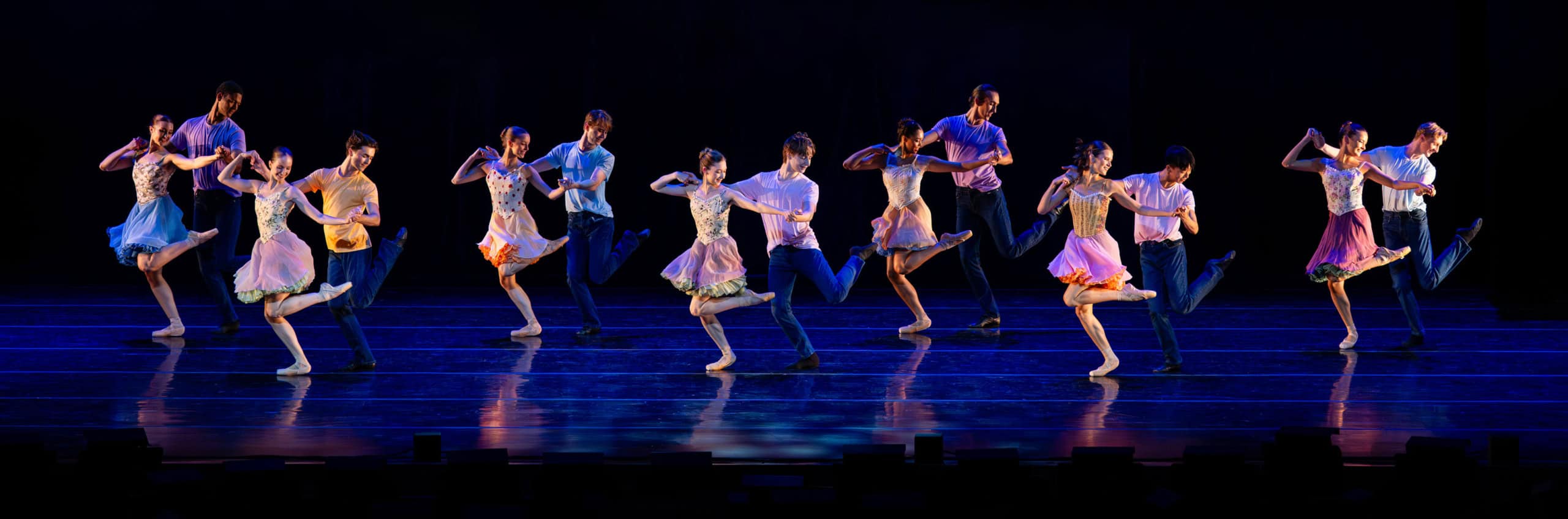 Dancers performing on stage in couples