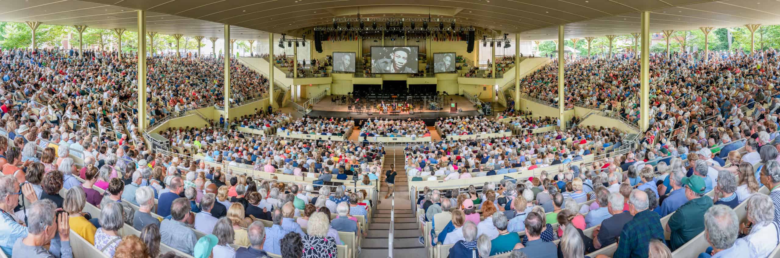 A crowded amphitheater during a lecture