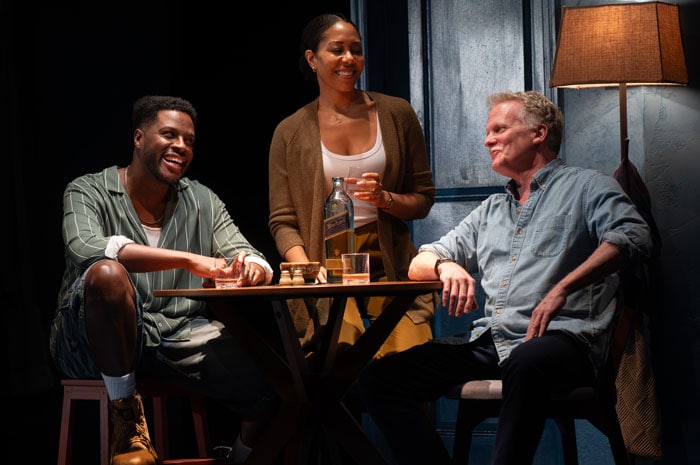 Actors sitting at a table, laughing