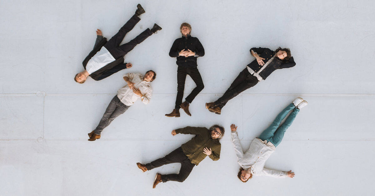 Wilco band members laying on the ground