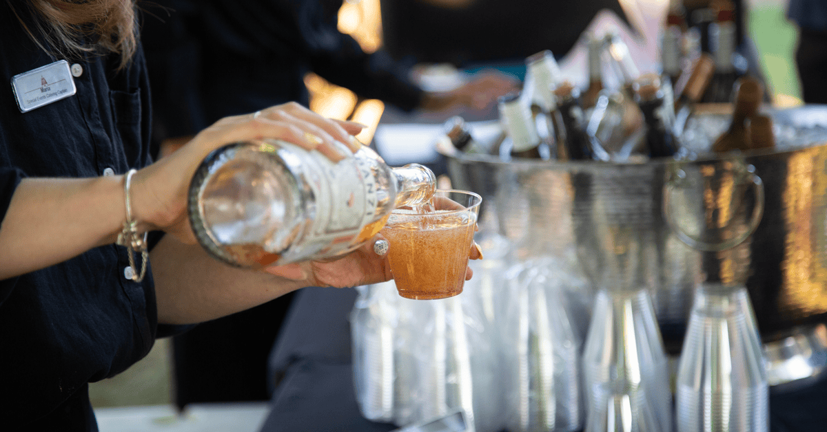 A woman pouring wine into a glass