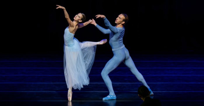A male and female dancer in blue